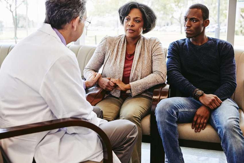 Doctor talking to woman and her son